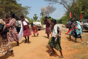 On right - the complete picture shows a smiling girl photographing the "fleeing" women using what appears to be a Nikon D Series camera.