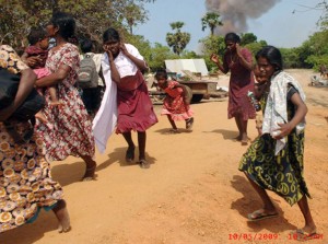 On left - People fleeing an artillery or similar attack with smoke rising in the distance.  Terrorists have resorted to such cowardly tactics triggering large explosions within the CSZ for international consumption.